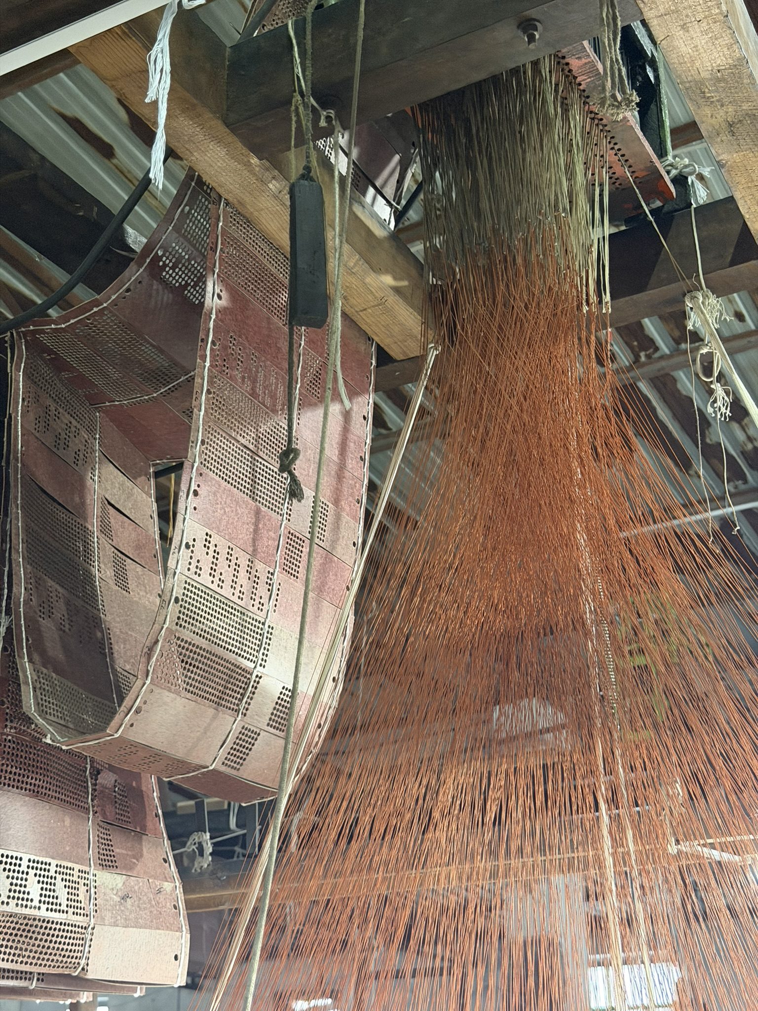 Weavers working at a traditional loom